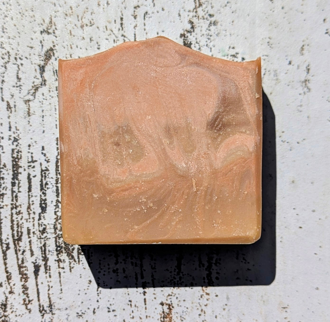 Bar of soap with a cat design on a textured surface