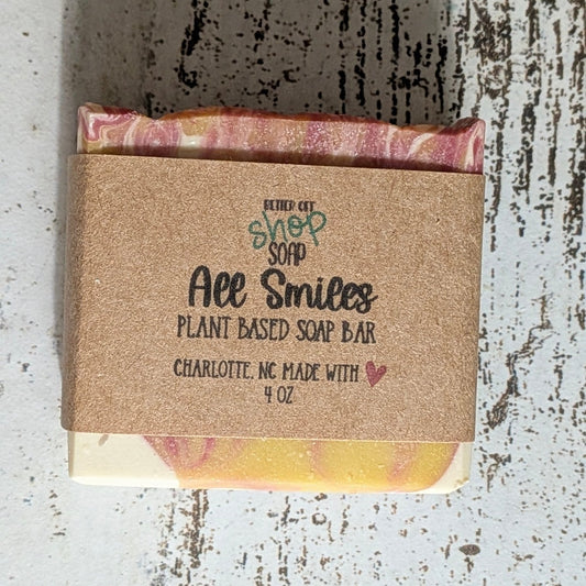 Bar of soap with a cardboard wrapper on a textured surface