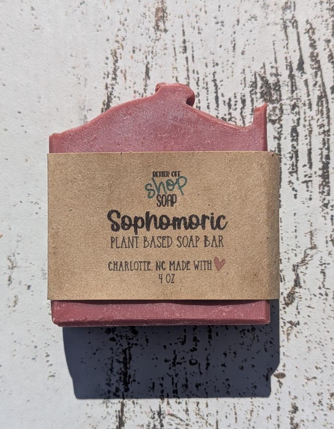 A vibrant hot pink Sophomoric handmade soap bar, featuring beveled edges for a sleek, polished look.