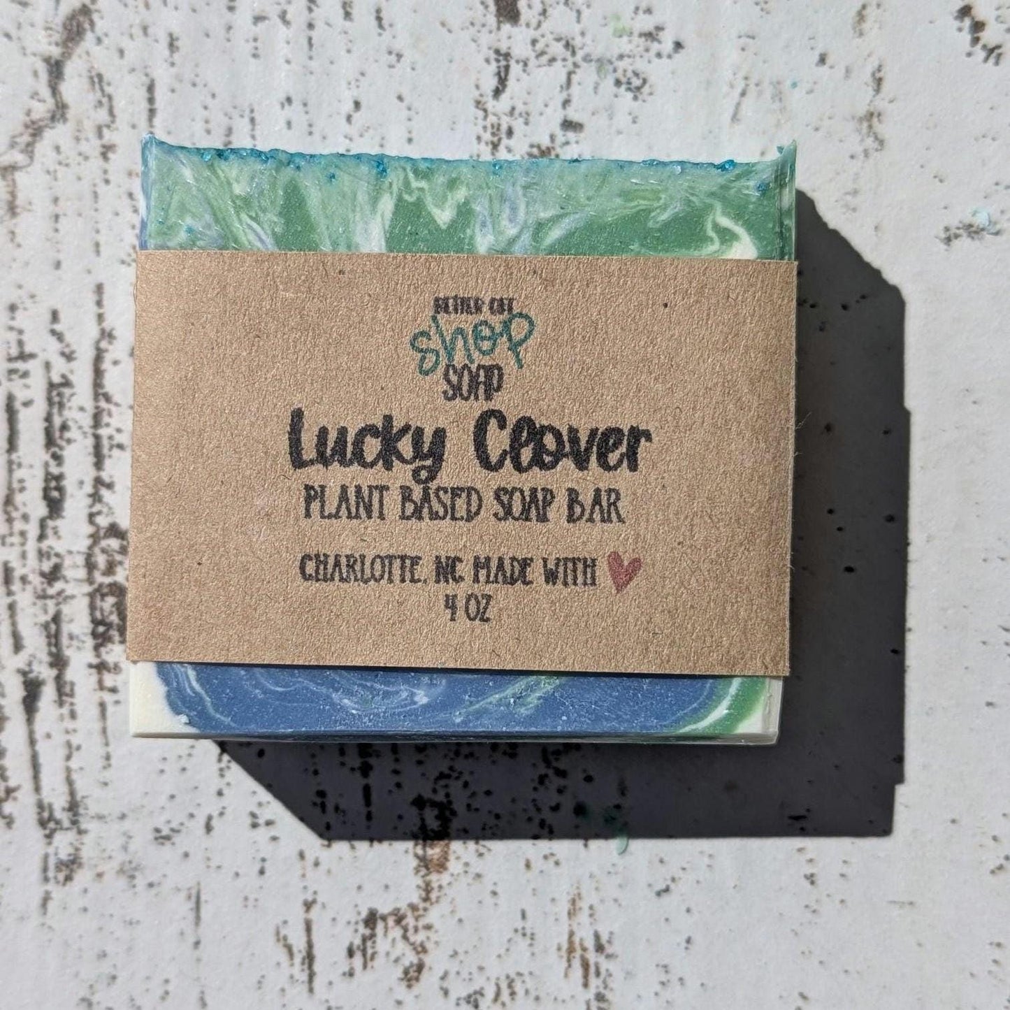 Handmade Lucky Clover Soap – A fresh, clean scent with swirls of green, blue and white, and teal glitter on top, perfect for St. Patricks Day or year-round luck! Made with skin-loving ingredients for a gentle, nourishing cleanse.