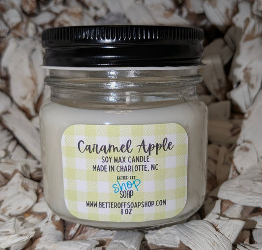 Candle jar labeled 'Caramel Apple' on a wooden background
